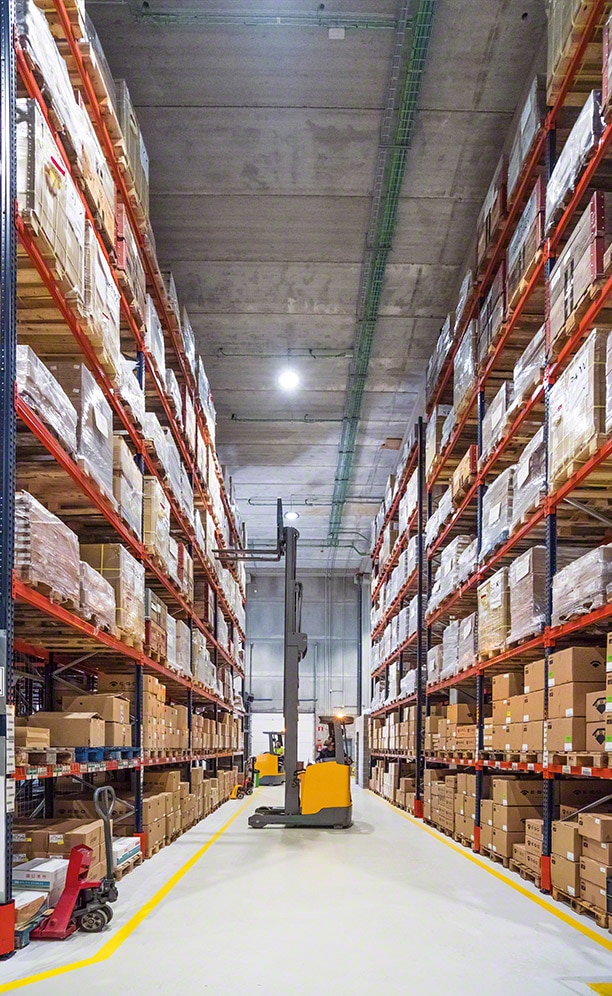 Reach trucks are the primary handling equipment operated in this warehouse to insert and extract pallets from their locations